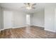 Spacious bedroom with a ceiling fan, neutral walls, wood-look flooring, and access to an ensuite bathroom at 154 Stable Brook Ln, Taylorsville, NC 28681