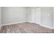 Bedroom with wood-look flooring, neutral walls, white trim and a double door closet at 154 Stable Brook Ln, Taylorsville, NC 28681