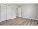 Bedroom featuring neutral walls, wood-look flooring, white trim and a double door closet at 154 Stable Brook Ln, Taylorsville, NC 28681