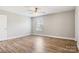 View of a bedroom with wood-look flooring, neutral walls, white trim, and a bright window at 154 Stable Brook Ln, Taylorsville, NC 28681
