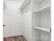 Walk-in closet with built-in shelving and wood-look flooring at 154 Stable Brook Ln, Taylorsville, NC 28681