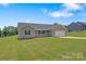 Charming single-story house featuring a well-maintained lawn and a long driveway to an attached garage at 154 Stable Brook Ln, Taylorsville, NC 28681