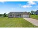 Single-story house featuring a well-maintained lawn and a long driveway leading to an attached garage at 154 Stable Brook Ln, Taylorsville, NC 28681
