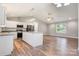Bright kitchen with white cabinets, stainless steel appliances, granite countertops, and wood-look flooring at 154 Stable Brook Ln, Taylorsville, NC 28681