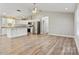 Bright kitchen with white cabinets, stainless steel appliances, granite countertops, and wood-look flooring at 154 Stable Brook Ln, Taylorsville, NC 28681