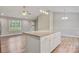 Bright kitchen with granite island opens to living room with natural light streaming through the windows at 154 Stable Brook Ln, Taylorsville, NC 28681