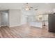 Bright kitchen with white cabinets, stainless steel appliances, granite countertops, and wood-look flooring at 154 Stable Brook Ln, Taylorsville, NC 28681