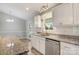 Bright kitchen with stainless steel appliances, granite countertops, and pristine white cabinets at 154 Stable Brook Ln, Taylorsville, NC 28681