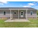 Covered back patio of home with white columns, an outdoor concrete space, and a grass yard at 154 Stable Brook Ln, Taylorsville, NC 28681