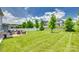 Large, grassy backyard featuring a stone fire pit area and well-maintained landscaping at 16008 Weeping Valley Dr, Fort Mill, SC 29715