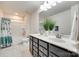 Bathroom featuring dual sinks, a large mirror, and a bathtub-shower combination at 16008 Weeping Valley Dr, Fort Mill, SC 29715