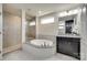 Spacious bathroom featuring a separate shower and soaking tub, along with a dark wood vanity at 16008 Weeping Valley Dr, Fort Mill, SC 29715