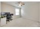 Well-lit bedroom showing a desk area, window and neutral carpet at 16008 Weeping Valley Dr, Fort Mill, SC 29715