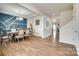 An elegant dining room featuring a blue accent wall, stylish chandelier, and rich hardwood flooring at 16008 Weeping Valley Dr, Fort Mill, SC 29715