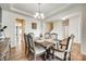 Dining room showcases hardwood floors, a stylish chandelier and an open transition to the home at 16008 Weeping Valley Dr, Fort Mill, SC 29715