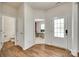 Entryway boasts hardwood floors, an exterior door with glass and a view into an office space at 16008 Weeping Valley Dr, Fort Mill, SC 29715