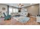 Living room showcases hardwood floors, a large sectional sofa and a ceiling fan at 16008 Weeping Valley Dr, Fort Mill, SC 29715