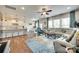 Spacious living area with hardwood floors, a large rug and an adjacent modern kitchen at 16008 Weeping Valley Dr, Fort Mill, SC 29715