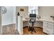 A cozy office nook has built-in desk space, hardwood floors and an office chair at 16008 Weeping Valley Dr, Fort Mill, SC 29715