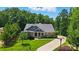 A beautiful, well-maintained home with a long driveway and mature trees, nestled in a serene setting at 161 Leaning Tower Dr, Mooresville, NC 28117