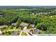 Aerial view of a home with a large, wooded lot, nestled in a lush green neighborhood at 161 Leaning Tower Dr, Mooresville, NC 28117