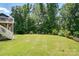 Expansive backyard with lush greenery and mature trees, perfect for outdoor activities and relaxation at 161 Leaning Tower Dr, Mooresville, NC 28117
