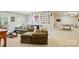 Expansive basement with comfortable seating, neutral carpeting, and walls decorated with license plates at 161 Leaning Tower Dr, Mooresville, NC 28117