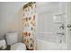 Bathroom with a white tub and shower, a shower curtain with owl pattern and a white toilet at 161 Leaning Tower Dr, Mooresville, NC 28117