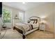 Bedroom featuring neutral carpet, a queen bed, and a window with natural light at 161 Leaning Tower Dr, Mooresville, NC 28117