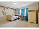 Bright bedroom featuring light-colored walls, white carpet and decorative floral accents at 161 Leaning Tower Dr, Mooresville, NC 28117