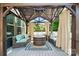 Inviting outdoor deck featuring an elegant gazebo with comfortable wicker seating and a fire pit at 161 Leaning Tower Dr, Mooresville, NC 28117