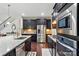 Modern kitchen with stainless steel appliances, granite countertops and dark cabinets at 161 Leaning Tower Dr, Mooresville, NC 28117