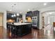 A stylish kitchen featuring dark cabinets, a large island, and stainless steel appliances at 161 Leaning Tower Dr, Mooresville, NC 28117