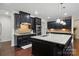 Modern kitchen with granite countertops, stainless steel appliances, and dark cabinetry at 161 Leaning Tower Dr, Mooresville, NC 28117