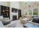 Elegant living room with fireplace, built-in shelves, and large windows at 161 Leaning Tower Dr, Mooresville, NC 28117