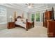 Main bedroom with tray ceiling and a large window at 161 Leaning Tower Dr, Mooresville, NC 28117