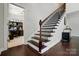 Beautiful staircase with dark wood treads and banister and a view of the office at 161 Leaning Tower Dr, Mooresville, NC 28117