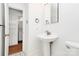 Bathroom with white fixtures, tiled floors, and access to a closet with washer and dryer at 1809 Jameston Dr, Charlotte, NC 28209