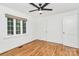 Bright bedroom with hardwood floors, a ceiling fan, and a large window with a view at 1809 Jameston Dr, Charlotte, NC 28209