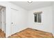 Bedroom with hardwood floors, a large window, and neutral decor for a calming atmosphere at 1809 Jameston Dr, Charlotte, NC 28209