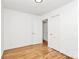 Neutral bedroom featuring hardwood floors, multiple closets, and modern ceiling fan at 1809 Jameston Dr, Charlotte, NC 28209