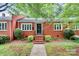 Charming brick home featuring a landscaped front yard and traditional architectural details at 1809 Jameston Dr, Charlotte, NC 28209