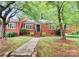 Charming brick home featuring well-maintained landscaping, a walkway, and a welcoming front entrance at 1809 Jameston Dr, Charlotte, NC 28209