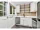 Modern kitchen with white cabinets, stainless steel appliances, and updated fixtures at 1809 Jameston Dr, Charlotte, NC 28209