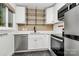Modern kitchen features stainless steel appliances, white cabinetry, and stylish tile backsplash at 1809 Jameston Dr, Charlotte, NC 28209