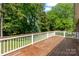 Spacious wooden deck surrounded by lush greenery offers outdoor relaxation at 2016 Townview Dr, Kannapolis, NC 28081