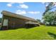 Manicured backyard featuring lush green grass, a brick home, and a spacious wooden deck at 2016 Townview Dr, Kannapolis, NC 28081