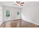 Bedroom featuring hardwood floors, neutral paint, a ceiling fan, and access to back porch at 2016 Townview Dr, Kannapolis, NC 28081