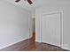 Bedroom featuring hardwood floors, neutral paint, a ceiling fan, and closet space at 2016 Townview Dr, Kannapolis, NC 28081