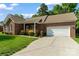 Lovely brick home featuring a spacious driveway and an attached two-car garage, complemented by lush green lawn at 2016 Townview Dr, Kannapolis, NC 28081